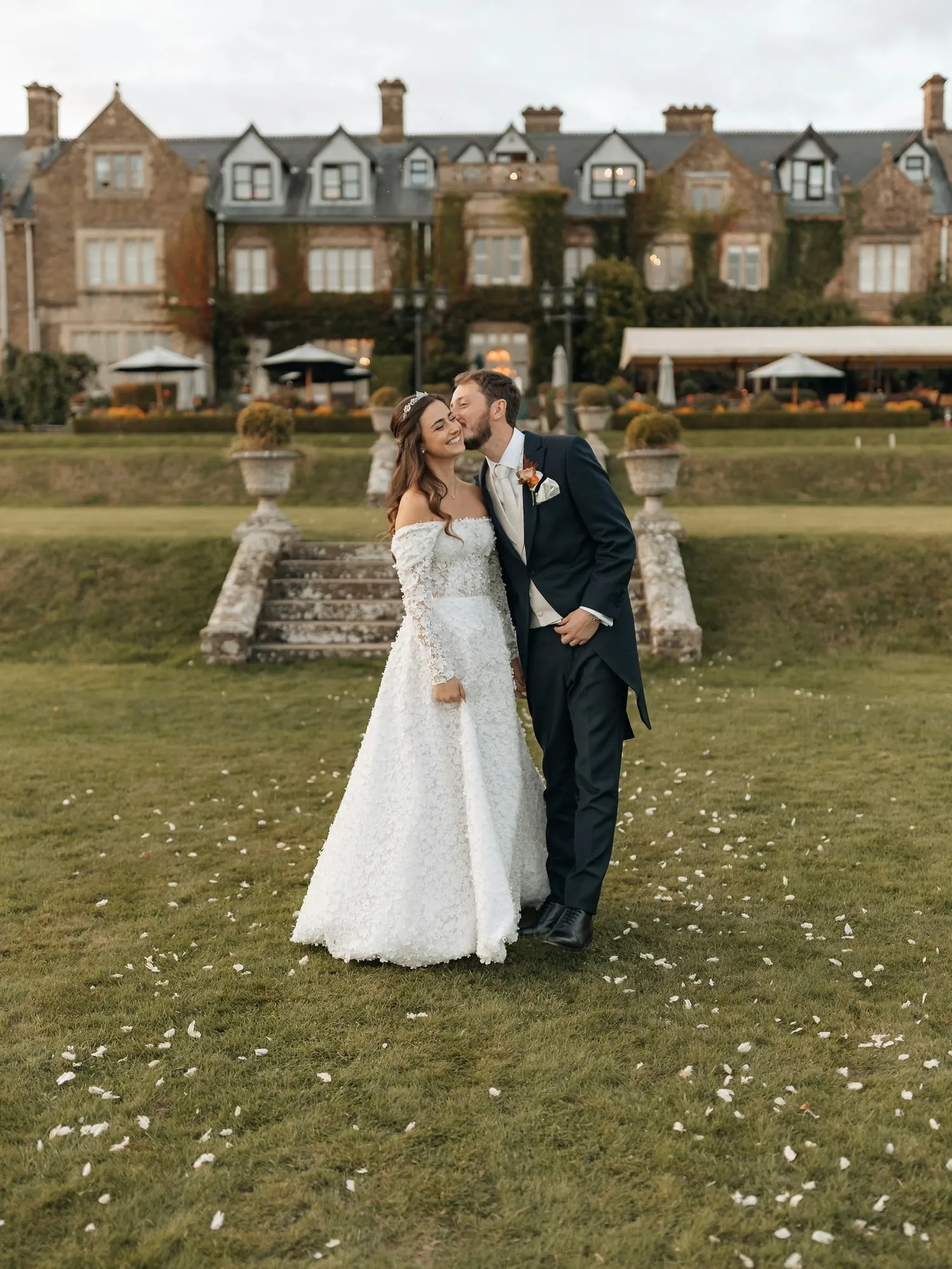 The couple on the lawn of a manor house