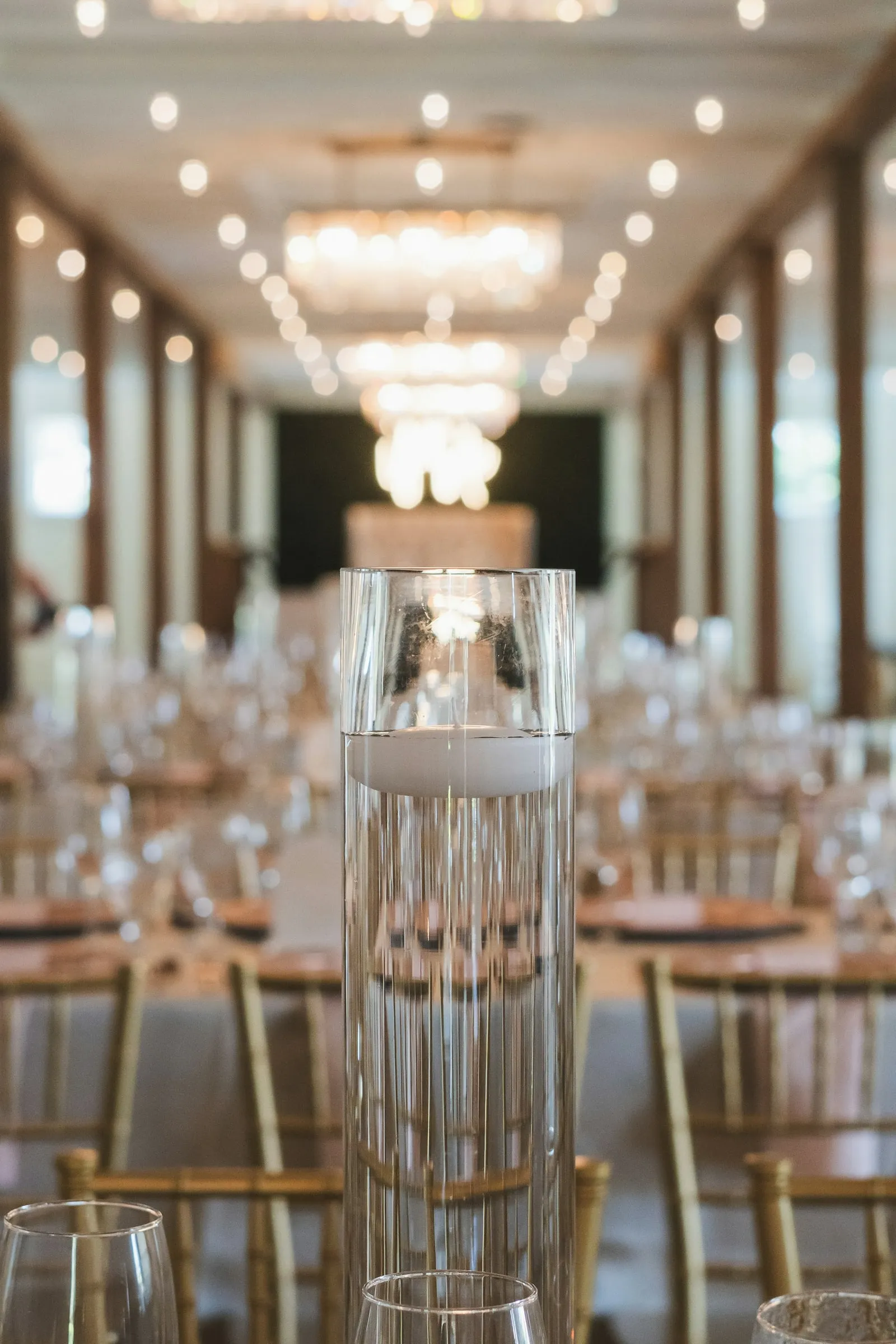 Banquet table, crystal glasses and golden lights