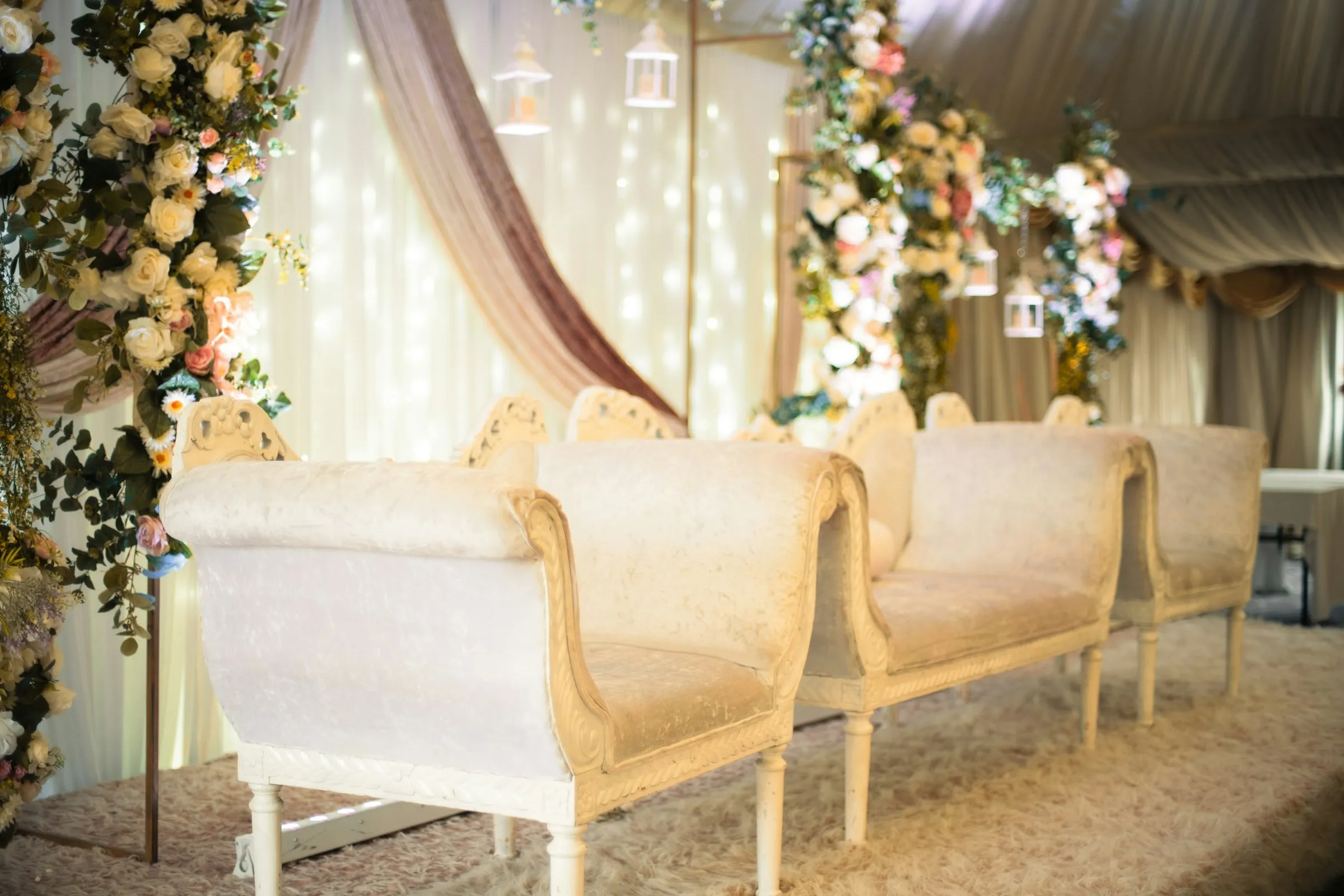 Reception lounge with white sofas and flowers