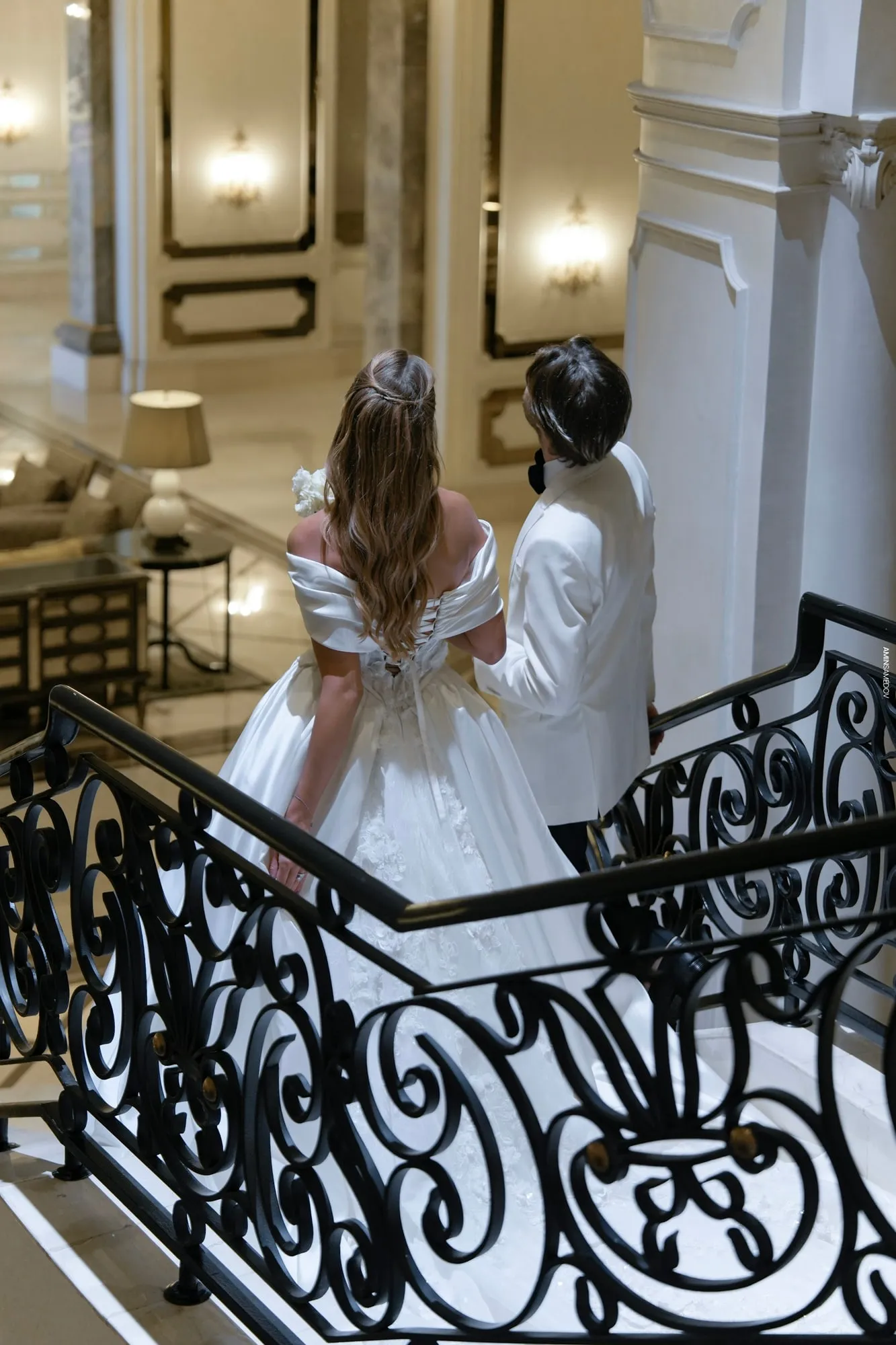The bride on a wrought-iron staircase