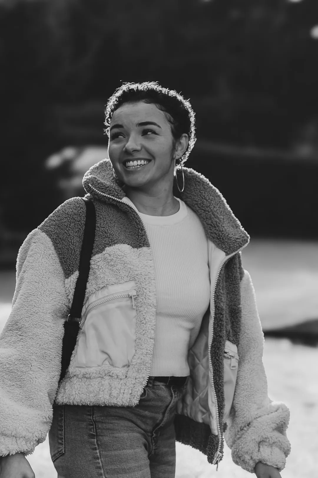 Young woman laughing, black and white portrait in natural light