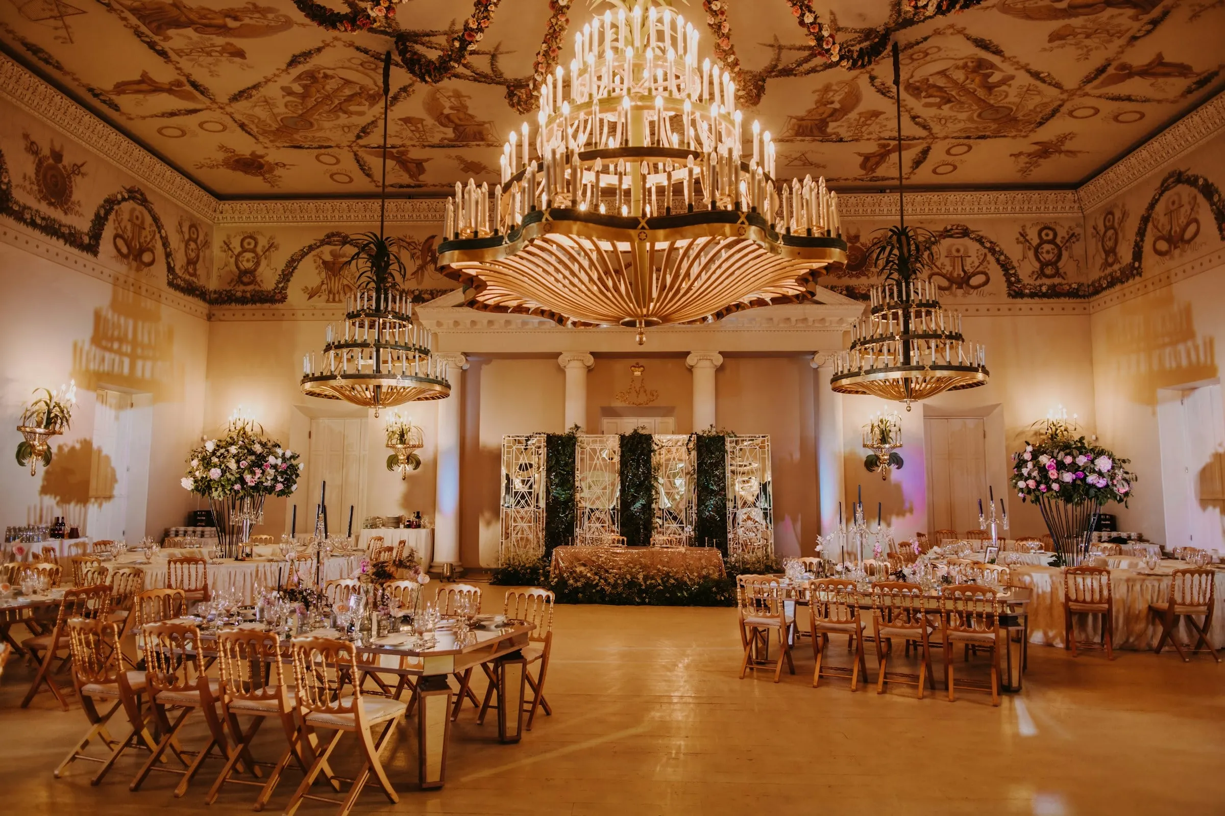 Gilded banquet hall under chandeliers